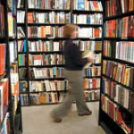 Sophistication at bargain prices Photo by Frank MullinAnne Marie Keohane, co-owner of Symposium Books on Westminster Street in Providence, walks among the stacks, restocking shelves at the downtown bookstore, which carries about 10,000 titles.