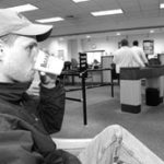 Photo by Dan HuntA customer enjoys a cup of coffee at Bank Rhode Island's Pitman Street branch in Providence, one of three locations where the bank has set up "Internet cafes." This particular customer waited in teh cafe to talk to a loan officer last Monday.
