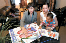 <b>Photo by Frank Mullin</b>Katie King, left, an asthma nurse with Neighborhood Health Plan of R.I., offers advice to Odette Rivera, of Providence, for treatment of her 3-year-old. Such hands-on outreach is an integral component of the insurer's approach to health care. <b>Photo by Frank Mullin</b><br>Katie King, left, an asthma nurse with Neighborhood Health Plan of R.I., offers advice to Odette Rivera, of Providence, for treatment of her 3-year-old. Such hands-on outreach is an integral component of the insurer's approach to health care.