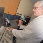 Photo by Brian McDonaldJohn Haefele of Unetixs Vascular demonstrates the North Kingstown company's vascular diagnostic machine on Martine Moscovita. The innovative machines combine two kinds of imaging - ultrasounds and exams to look for vascular problems. 