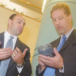 R.I. military device aids health workers JOHN HALL, left, from Vox Tec, shows a Phraselator to Merril Thomas, Providence Community Health Center CEO.