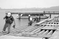 <b>WORKERS REPAIR DOCKS</b> at Conley's Wharf in Providence. <b>WORKERS REPAIR DOCKS</b> at Conley's Wharf in Providence.