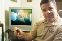 <b>Vic Pichette,</b> owner of Genesis Investigations & Security Services, demonstrates a micro video camera for a photographer. <b>Vic Pichette,</b> owner of Genesis Investigations & Security Services, demonstrates a micro video camera for a photographer.