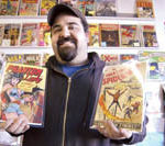A superhero among collectors PBN photo/Frank Mullin
Timeless: Robert Yeremian, owner of The Time Capsule, a comic book and collectibles store in Cranston, holds copies of Phantom Lady No. 17, circa 1948, and the first Spider-Man comic book, together worth about $5,000.