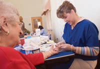 PBN photo/Stephanie Ewens
<b>An ounce of prevention:</b> Nurse Tracy Gallaway, right, of the Blue Cross & Blue Shield of Rhode Island Wellness Van, tests the blood glucose level of Jeanette Lambado at the Salvatore Mancini Resource and Activity Center in North Providence. PBN photo/Stephanie Ewens<br><br>
<b>An ounce of prevention:</b> Nurse Tracy Gallaway, right, of the Blue Cross & Blue Shield of Rhode Island Wellness Van, tests the blood glucose level of Jeanette Lambado at the Salvatore Mancini Resource and Activity Center in North Providence.