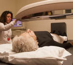 The hospital price riddle PBN photo/Stephanie Ewens
Valuable service: Technician Doreen Emgeian, of Women & Infants Hospital, conducts a bone density scan to screen for osteoporosis on Ellen Heath of Cranston.