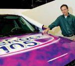 A digital take on the big picture PBN photo/Stephanie Ewens
Big Job: Jim Larkin, owner of Graphic Innovations, a large-format printer in Providence, shows off one of his latest projects: wrapping a car for promotions by a local radio station.