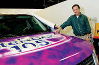 PBN photo/Stephanie Ewens
<b>Big Job:</b> Jim Larkin, owner of Graphic Innovations, a large-format printer in Providence, shows off one of his latest projects: wrapping a car for promotions by a local radio station. PBN photo/Stephanie Ewens<br><br>
<b>Big Job:</b> Jim Larkin, owner of Graphic Innovations, a large-format printer in Providence, shows off one of his latest projects: wrapping a car for promotions by a local radio station.