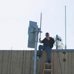 Statewide wireless network starts taking shape PHOTO COURTESY STRATUM BROADBAND A WORKER installs RI-WINs equipment on top of the Brown University Sciences Library.