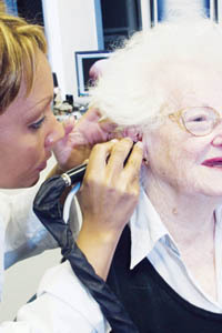 PBN Staff photo/Stephanie Ewens
<b>Anna Wittich,</b> of Providence, gets her ears inspected by Janet Rocha at a Beltone New England hearing center in Warwick. PBN Staff photo/Stephanie Ewens<br><br>
<b>Anna Wittich,</b> of Providence, gets her ears inspected by Janet Rocha at a Beltone New England hearing center in Warwick.