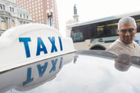 PBN Staff photo/Stephanie Ewens<b>Raul Pizano,</b> of Dominican Cab Inc., waits for his next fare at Kennedy Plaza. A bill approved by the R.I. Senate would require $300,000 of insurance coverage for each taxi. PBN Staff photo/Stephanie EwensRaul Pizano, of Dominican Cab Inc., waits for his next fare at Kennedy Plaza. A bill approved by the R.I. Senate would require $300,000 of insurance coverage for each taxi.