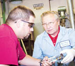 New England Tech’s programs are offered across the country PBN Staff photo/Stephanie Ewens
Instructor Robert Plante aids Eric McKeon, left, during his class on basic oil heat technology at New England Tech, which has provided corporate training since 1986.