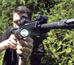 R.I. manufacturers aim for big government contracts PBN photo/Frank Mullin
Matthew Wolfe, vice president of sales at Emissive Energy, displays the T-3 light, mounted on an AR-15 rifle. The T-3 is currently used on combat rifles in Iraq.