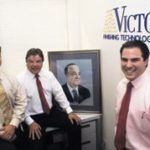 New speed helps metal finisher pull out of receivership PBN Staff photo/Stephanie Ewens
Three generations of Marandolas: from left, Edward III, Edward Jr., Edward Sr. (portrait), who started the company in 1941, and Marc E. Marandola.