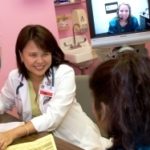 Video interpretation connects patients, physicians PBN Staff photo/Stephanie Ewens
Pediatrician Dr. Carolina Cerezo consults a patient with the help of interpreter Ana Marin, who communicates with the doctor, the patient and her mom through a video conferencing system set up by Neighborhood Health Plan of Rhode Island.