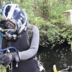 PBN Staff photo/Stephanie Ewens
A scuba diver gets ready to inspect the Harris Mill dam in the Pawtuxet River, which developers aim to use to generate hydroelectric power.