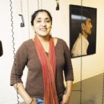 ANNU PALAKUNNATHU MATTHEW took a one-year sabbatical fromURI to document the Americanization of call-center workers in India. Her audio-visual exhibit, above, incorporating photos and recorded interviews, is on display at the URI Fine Arts Center through Dec. 10. / 