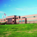 THE FORMER GTECH Corp. headquarters will be occupied by Amgen as part of a plan for the site that also includes more than 350,000 square feet of new development. / 