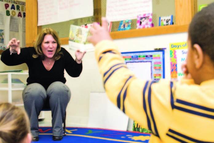 PATTY CARBONE, child care director at CFS of Newport County, reads and acts out Maurice Sendak's 'Where the Wild Things Are' for a class at the child development center. / 