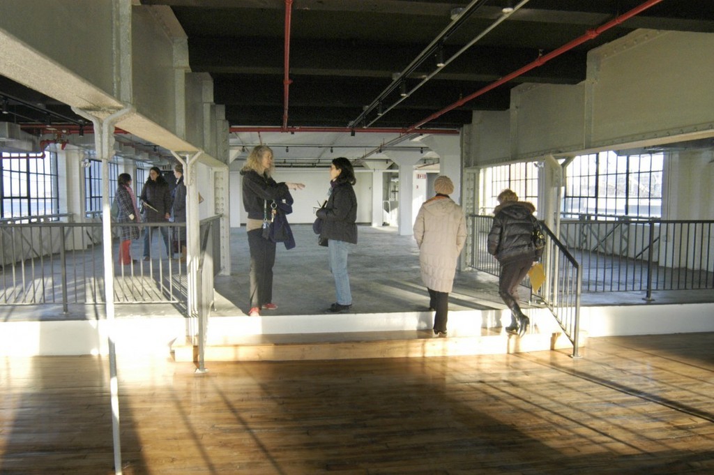 A GROUP OF prospective tenants tours the building at Conley's Wharf that the Partnership for Creative Industrial Space is leasing out. The former coal-gasification facility is being turned into offices and studios for artists and designers. / 