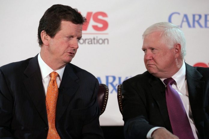THE MERGER PLAN announced in November by Thomas M. Ryan, left, president and CEO of CVS, and Mac Crawford, his counterpart at Caremark Rx, today hit its first delay. / 