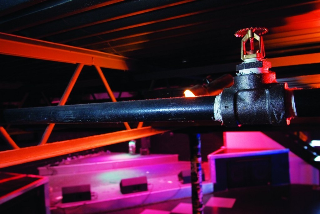 FOR MANY R.I. BUSINESSES the new fire code boils down to cost, with sprinkler systems and alarms costing upwards of tens of thousands of dollars.  / 