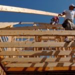IN THE SOUTH and West, construction surged last month, boosting national figures. Above, builders frame the roof of a house in Bentonville, Ark. / 