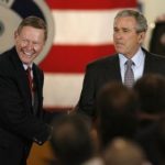 Alternative energy a national security issue,<br> Bush tells Ford, GM workers ALAN MULALLY, left, Ford Motor Co. president and CEO, greets President George W. Bush after he toured the Missouri factory that makes the Ford Escape and Mariner hybrids. /