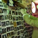 A PATRON tacks up a photo of his dog on the wall of the Decatur Lounge, which had until its recent closing been a dog-friendly neighborhood bar in the West End.  / 