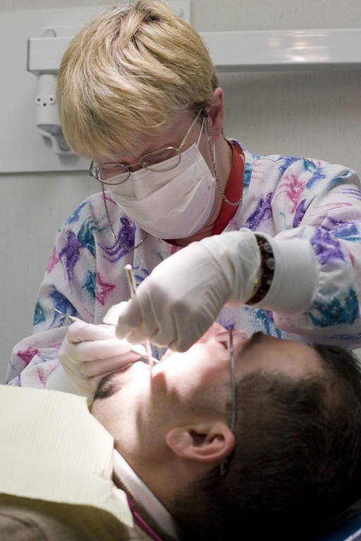 DENTAL HYGIENIST Mary O?Connor works on a patient at Blackstone Valley Community Health Care, which is building a much larger dental facility nearby. / DENTAL HYGIENIST Mary O?Connor works on a patient at Blackstone Valley Community Health Care, which is building a much larger dental facility nearby. /
