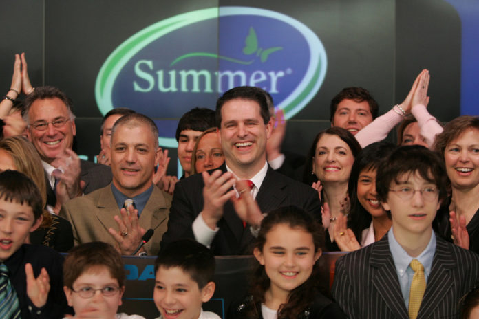 SUMMER INFANT President and CEO Jason Macari, center, and to his left, Steven Gibree, executive vice president of product development, celebrate with other company executives and family members after ringing the opening bell at Nasdaq on March 20. / SUMMER INFANT President and CEO Jason Macari, center, and to his left, Steven Gibree, executive vice president of product development, celebrate with other company executives and family members after ringing the opening bell at Nasdaq on March 20. /