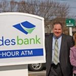 SLADES BANK's Dennis Wyatt, senior VP and director of retail banking, and Seekonk manager Lisa Russo, right, with the new sign. / 