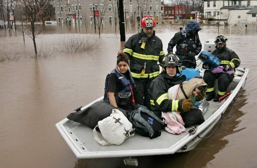 A FAMILY in Bound Brook, N.J., is borne to safety Monday by local firefighters after the storm left their neighborhood underwater. / A FAMILY in Bound Brook, N.J., is borne to safety Monday by local firefighters after the storm left their neighborhood underwater. /