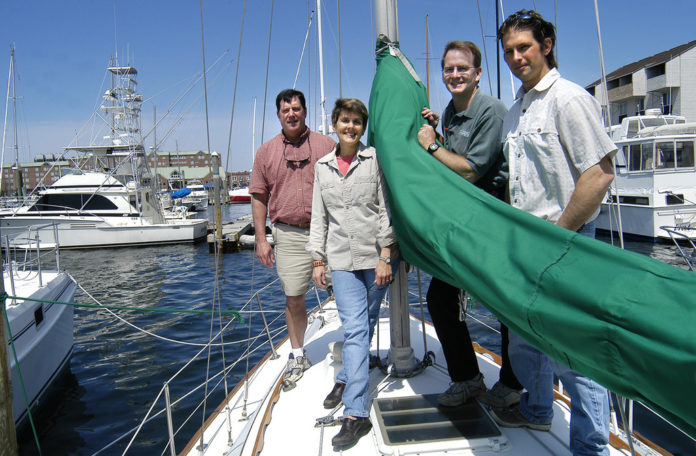 CRUISING WORLD and Sailing World staff members, from left, Mark Pillsbury, CW senior editor; Elaine Lembo, CW managing editor; John Burnham, CW editor and SW editorial director; and Dave Reed, SW editor, aboard a boat at the Newport Marina. / CRUISING WORLD and Sailing World staff members, from left, Mark Pillsbury, CW senior editor; Elaine Lembo, CW managing editor; John Burnham, CW editor and SW editorial director; and Dave Reed, SW editor, aboard a boat at the Newport Marina. /