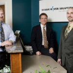 Web developer is no one-trick pony BRAVE RIVER SOLUTIONS co-founders Ernie Gaines, center, and James McAssey, right, say they have kept the firm strong by keeping its services diverse. With them is Tom Durkin, left, their senior sales representative. /