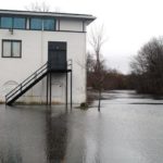 RHODES IN THE PAWTUXET: The river that gave the Cranston banquet hall its name surrounds the facility after the April storm. / 