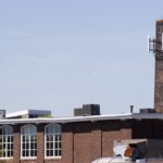 THE SMOKESTACK of the Union Paper Co. building in Providence is one of many high spots where local wireless service providers have mounted antennae. / 