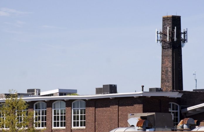 THE SMOKESTACK of the Union Paper Co. building in Providence is one of many high spots where local wireless service providers have mounted antennae. / THE SMOKESTACK of the Union Paper Co. building in Providence is one of many high spots where local wireless service providers have mounted antennae. /