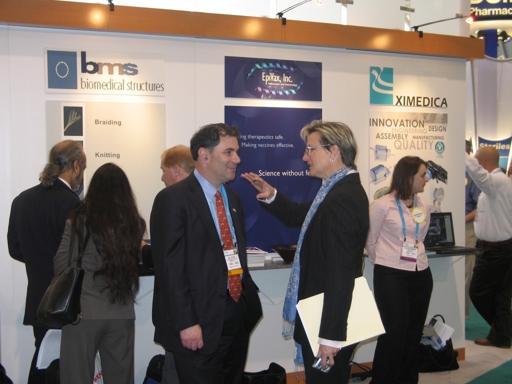 SAUL KAPLAN, executive director of the R.I. Economic Development Corporation, chats with Dr. Annie De Groot, CEO of Epivax, in front of the state's booth at BIO 2007. / 