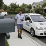 GOING UP: New postal  rates and rules take effect Monday, April 14. Above, USPS letter carrier Aldo Vasquez delivers mail in Irvine, Calif., using a fuel-cell powered minivan. / 