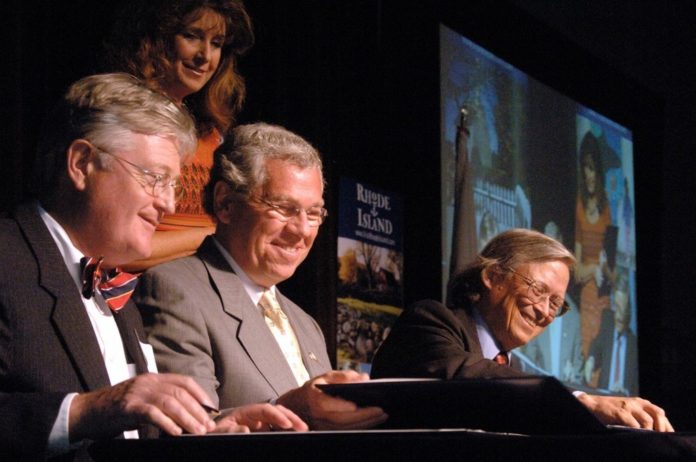 JONATHAN STEVENS, left, of Preserve Rhode Island, Gov. Donald L. Carcieri and National Geographic's Jonathan Tourtellot sign the Geotourism Charter yesterday as Carcieri aide Sue Stenhouse looks on. / 
