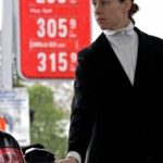 LIZ HALE fuels her car on Friday at a Sunoco station in Cambridge, Mass., as gas prices nationwide  surged into record territory. / 
