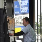 A MOTORIST in Chicago fills up his van on Thursday for the Memorial Day weekend. / 