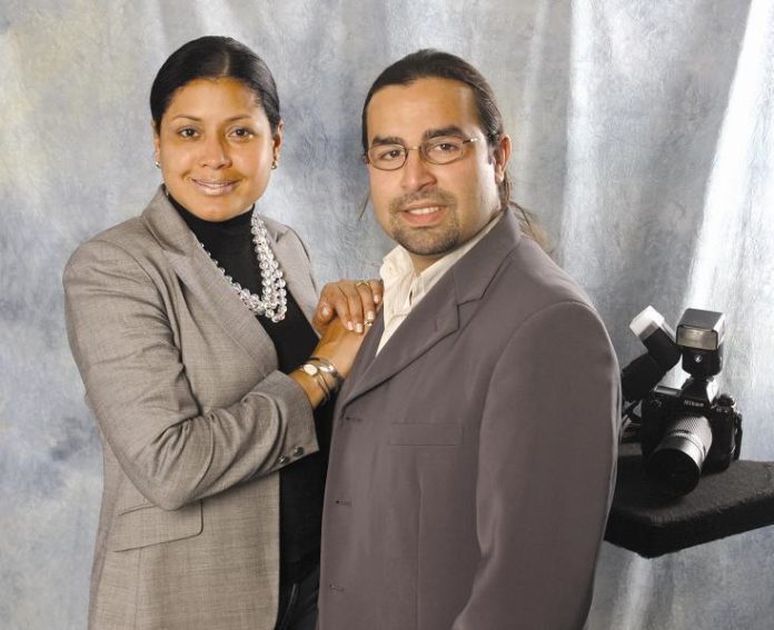 NURIS MARCANO, right, has become an indispensible asset to the photo studio launched by her husband, Erick Romero, not only handling the bookkeeping but even taking pictures. / NURIS MARCANO, right, has become an indispensible asset to the photo studio launched by her husband, Erick Romero, not only handling the bookkeeping but even taking pictures. /