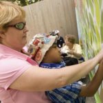 CVS Trust supports zoo’s accessible tree house MEETING STREET student Mack, 9, is helped to attach a symbolic leaf to the CVS All Kids Can Tree House banner at Roger Williams Park Zoo during Friday's dedication at the site of the future tree house. /