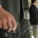 ADULTS ONLY: Cumberland Farms has settled charges it sold tobacco to someone younger than 18 at least 134 times from 2004 to mid-2006, the Mass. Attorney General's Office said. Above, a man smokes a Marlboro Light outside his workplace in Denver, Colo. / 