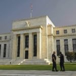 GUARDS watch the Federal Reserve building in Washington, D.C., as the Federal Open Market Committee meets inside. Recent economic reports have left analysts unsure whether the FOMC will act to raise interest rates. / 