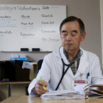 Facing a rising tide of uninsured DR. CHANG LEE, a retired surgeon, volunteers at the Rhode Island Free Clinic twice a month. The clinic, which serves about 1,600 uninsured patients, has a large new facility, but not enough volunteers to meet a fast-rising demand for services. /