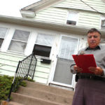 Skip Ponte reads off the legal notice announcing the auction for a property 
at 440 Benefit St. in Pawtucket.
 / 