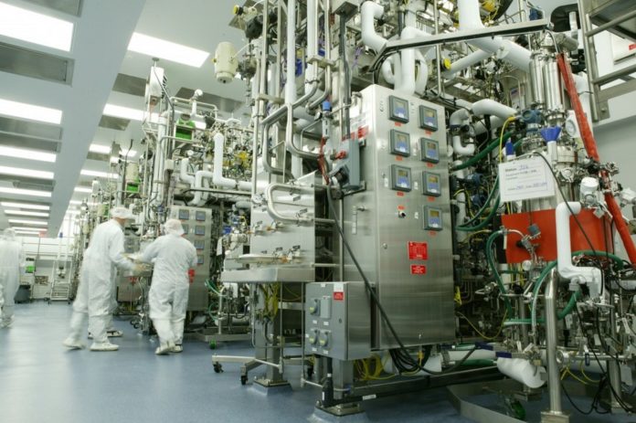 BIOTECHNOLOGY GIANT AMGEN (its West Greenwich production facility is shown here) announced plans to cut jobs and capital spending as sales fall for two of its products. / 
